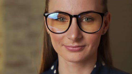 Close Up of Smiling Young Woman in Glasses