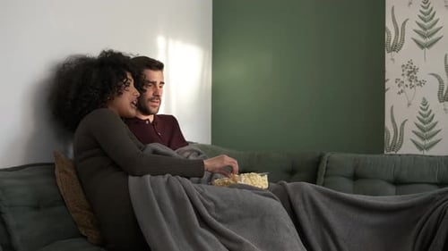 Couple Relaxing at Home with Popcorn and Movie