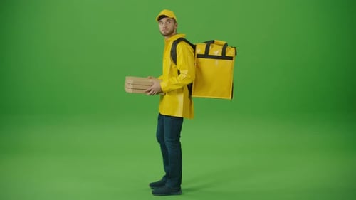 Green Screen Delivery Man in Yellow Uniform With Thermal Backpack Brings Pizza