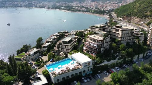 A drone flies over a beautiful hotel in Budva. Summer rest. Montenegro. Aerial view.