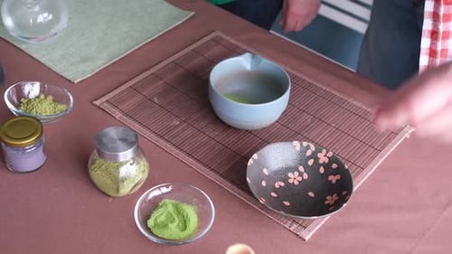 Preparing matcha tea with bamboo whisk
