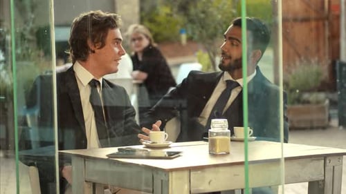 Young Multiracial Mobile Business Men Discussing New Business Deal While Visiting Local