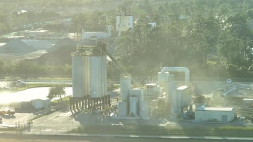 Concrete Manufactory at Cement Mixing Factory Industrial Area with Cargo Trucks and Heavy Building