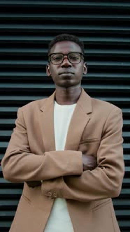 Outdoor Portrait of Serious Young Male Office Worker with Crossed Arms