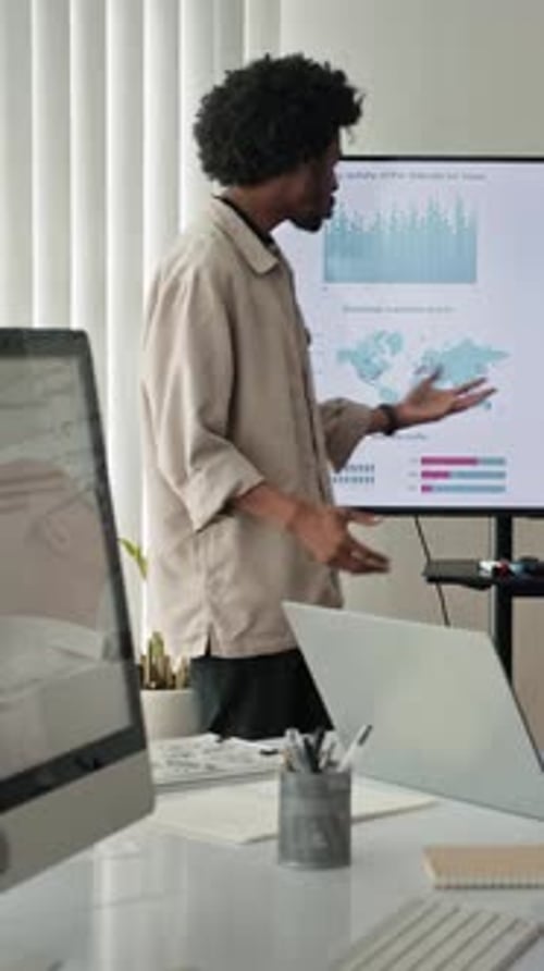 Analyst Talking about Business Chart to Colleagues at Office