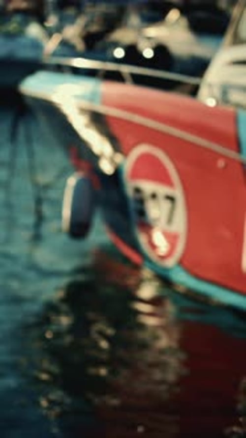 Soft focus shot of a boat bow partially reflected in the water. Vertical