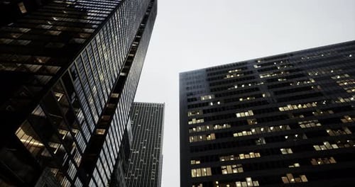City Skyline at Dusk with Modern Skyscrapers and Glowing Windows