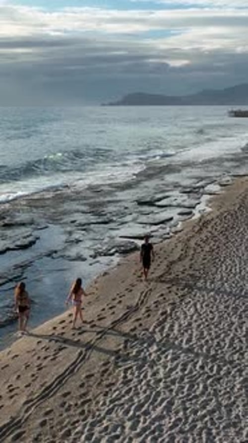 Vertical Video Two Girls Walking on the Beach Vacation on the Mediterranean Sea