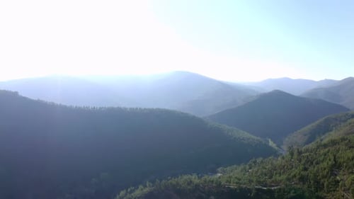 A full shot of mountains and clouds near a river. Camera moves forward. 4k footage video Sunset in m