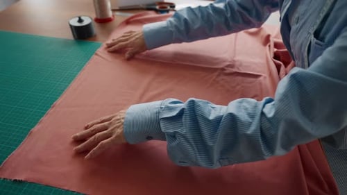 Seamstress Putting Fabric on Working Table Closeup Handmade Clothes Sewing Professional Dressmaker