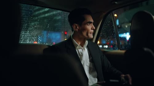 Young Adult Man Rides in Car at Night