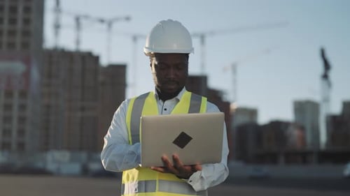 Large Construction Site with New Modern Buildings Foreman Using Laptop Architect Controlling Project