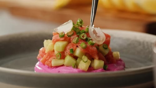 Chilean Salmon Tartar Seviche with Avocado and Cucumber on Purple Cream Cheese Adding Green and