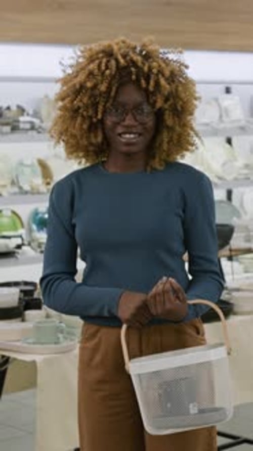 Vertical Portrait of Happy Black Woman Shopping at Kitchenware Store