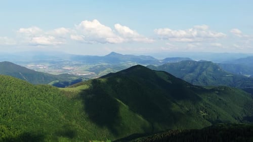 Aerial Drone Shot of Green Hills with Cloud Shadows Moving on Forest Slopes