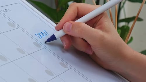 Female Hand Writing Text DONT IGNORE YOUR OWN POTENTIAL with Marker on Whiteboard
