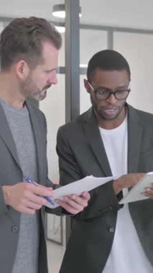 African Entrepreneur Discussing Work with Employee, Standing in Office, vertical video