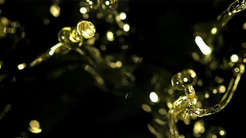 Golden Liquid Splatter in Slow Motion on Black
