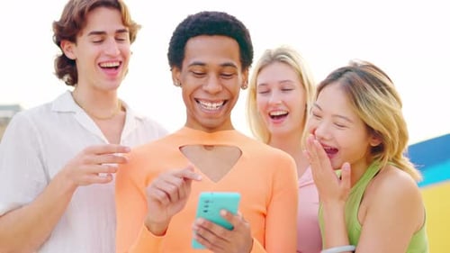 Friends Laughing at Mobile Phone Content Together