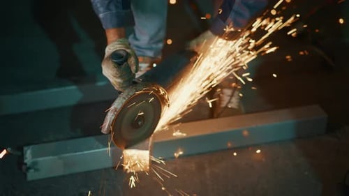 Steel Beam Sparks Fly Intense Sparks Erupt As Handheld Grinder Cuts Through Structural Steel Beam