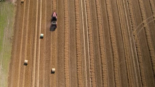 Top down view of collecting hay, Harvesting on farm field.