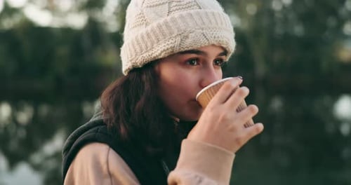 Woman Drinks Coffee Outdoors on a Fall Day