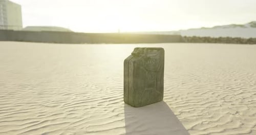 Bright Sunset Illuminating a Canister on a Sandy Beach Landscape