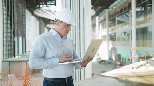 Construction Worker Indoors Engineer Man Architect Checking Building Construction Site Tablet