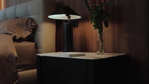 Bedside Table with Lamp, Roses, and Book