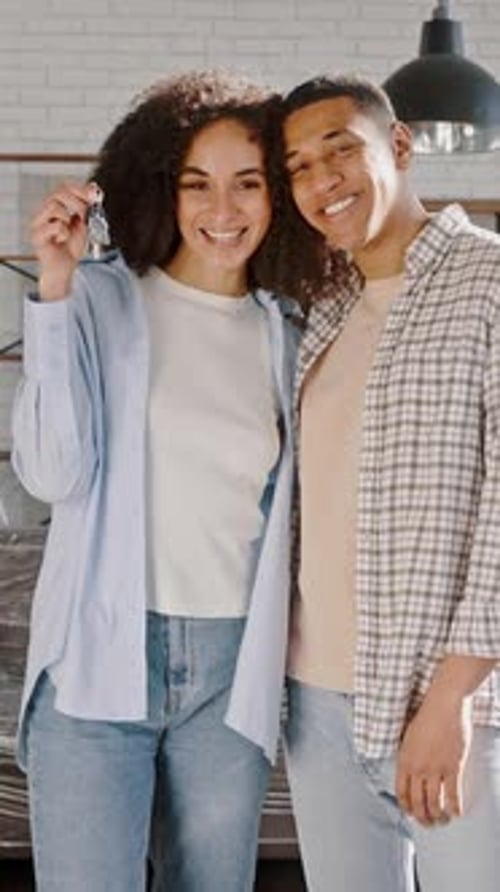 Young Multiethnic Couple Shares Positive Emotions Smiles Shows Keys of New House the are Moving