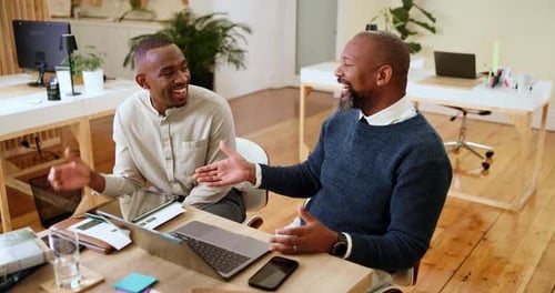 Two Men Shaking Hands in an Office