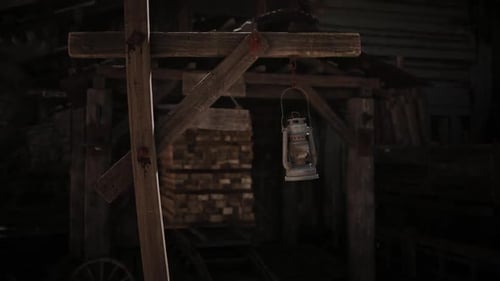 Rusty Lantern Swinging in Old Mine Entrance