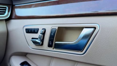 Luxury Car Door Handle and Control Panel Close-Up.
