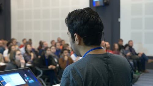 Presentation in conference room to diverse audience.