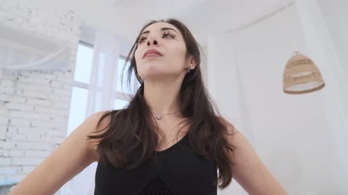 Young Woman Doing Neck Stretches Indoors