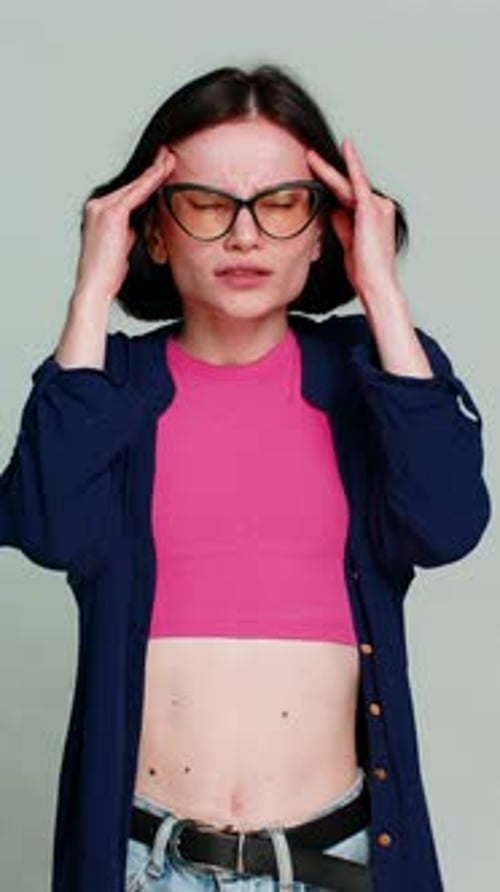 Woman Suffering Headache or Stress in Studio