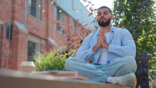 Bearded Man Meditating Peacefully Outdoors