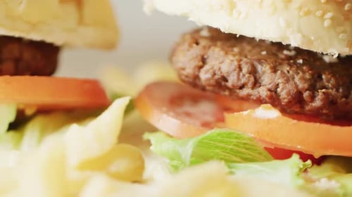 Video close up of two hamburgers with salad in burger buns