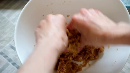 Hands Mixing Ingredients in White Bowl Close Up