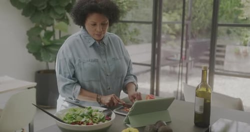 Woman Cutting Vegetables for Salad in Kitchen