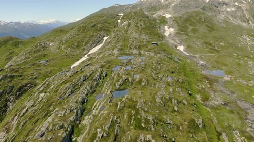Sideways flight to the right over small lakes on Grimselpass in the Swiss alps.