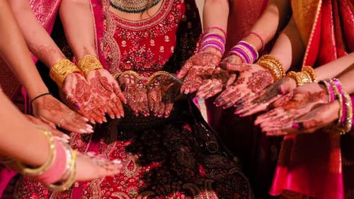 Bridesmaids With Hands Together At Wedding Ceremony