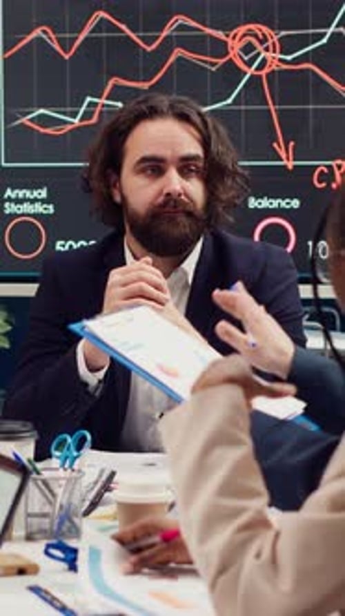 Businessmen Collaborate During Corporate Meeting in Modern Office