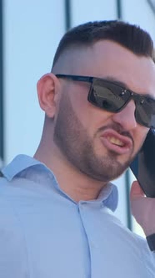 Man Talks Angrily on Phone in City