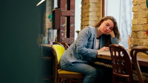 in Bookstore Near Window a Beautiful Student is Sitting Boring Reading Books Preparing for Exams