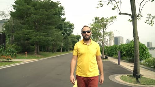 Man Walking in City Park 30s