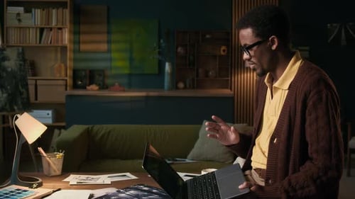 Adult on Laptop Video Call in Home Office