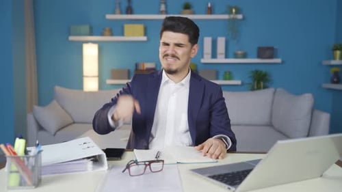 Man Reacts with Frustration in His Home Office