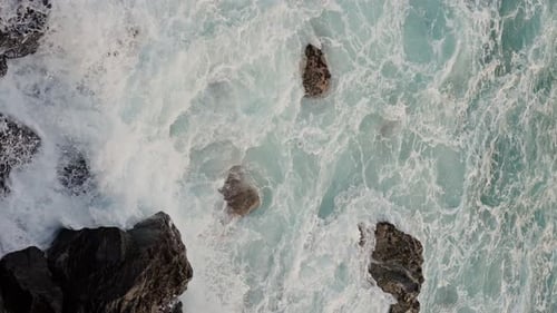 An Aerial View of a Vast Expanse of Water Bordered By Rocky Formations