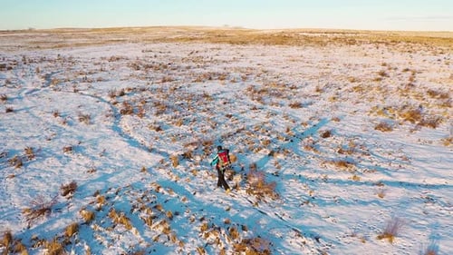 Lonely Human Walking Through Snowy Desert